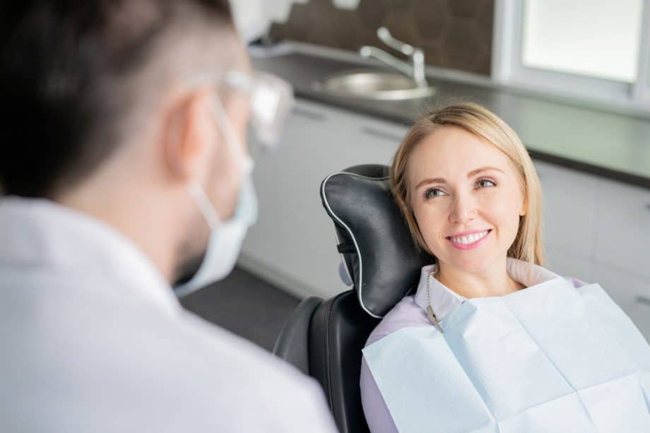 smiling female patient in dental chair