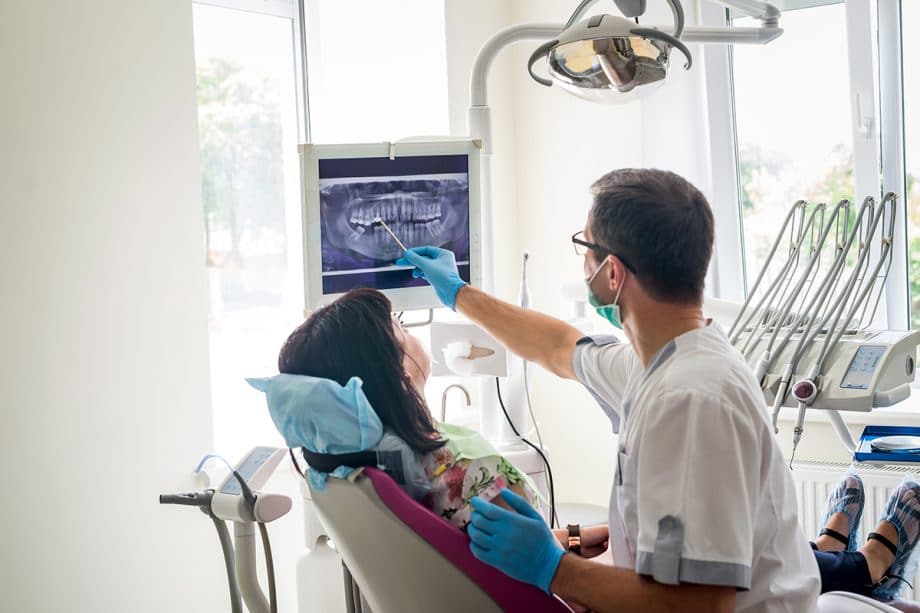 dentist showing patient her dental x-ray